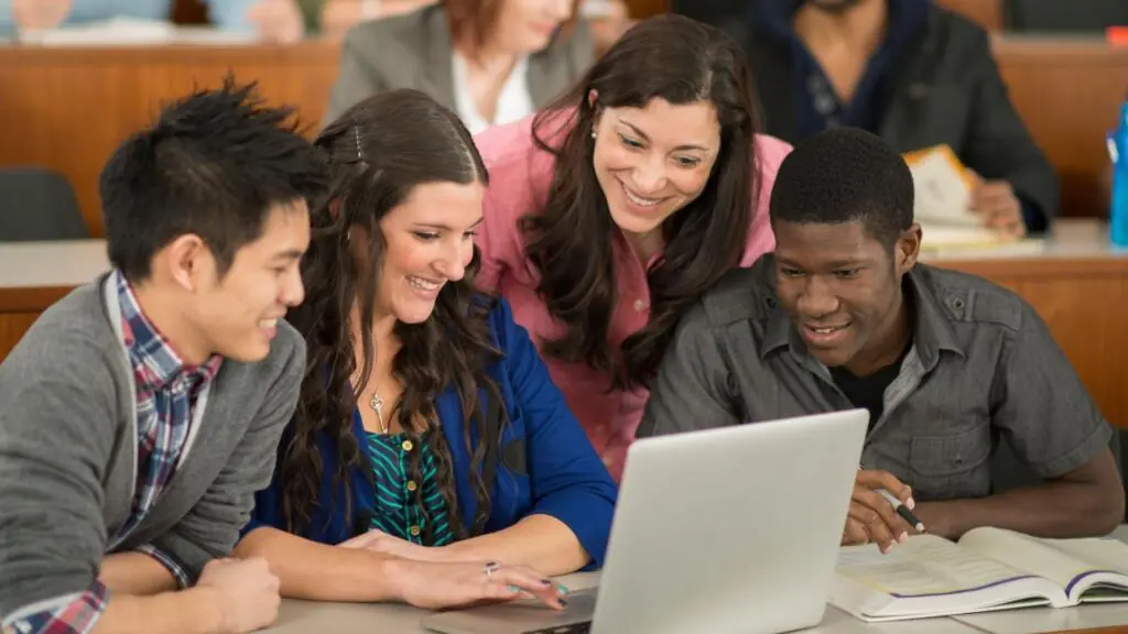 Group of diverse students and their teacher learning new concepts
