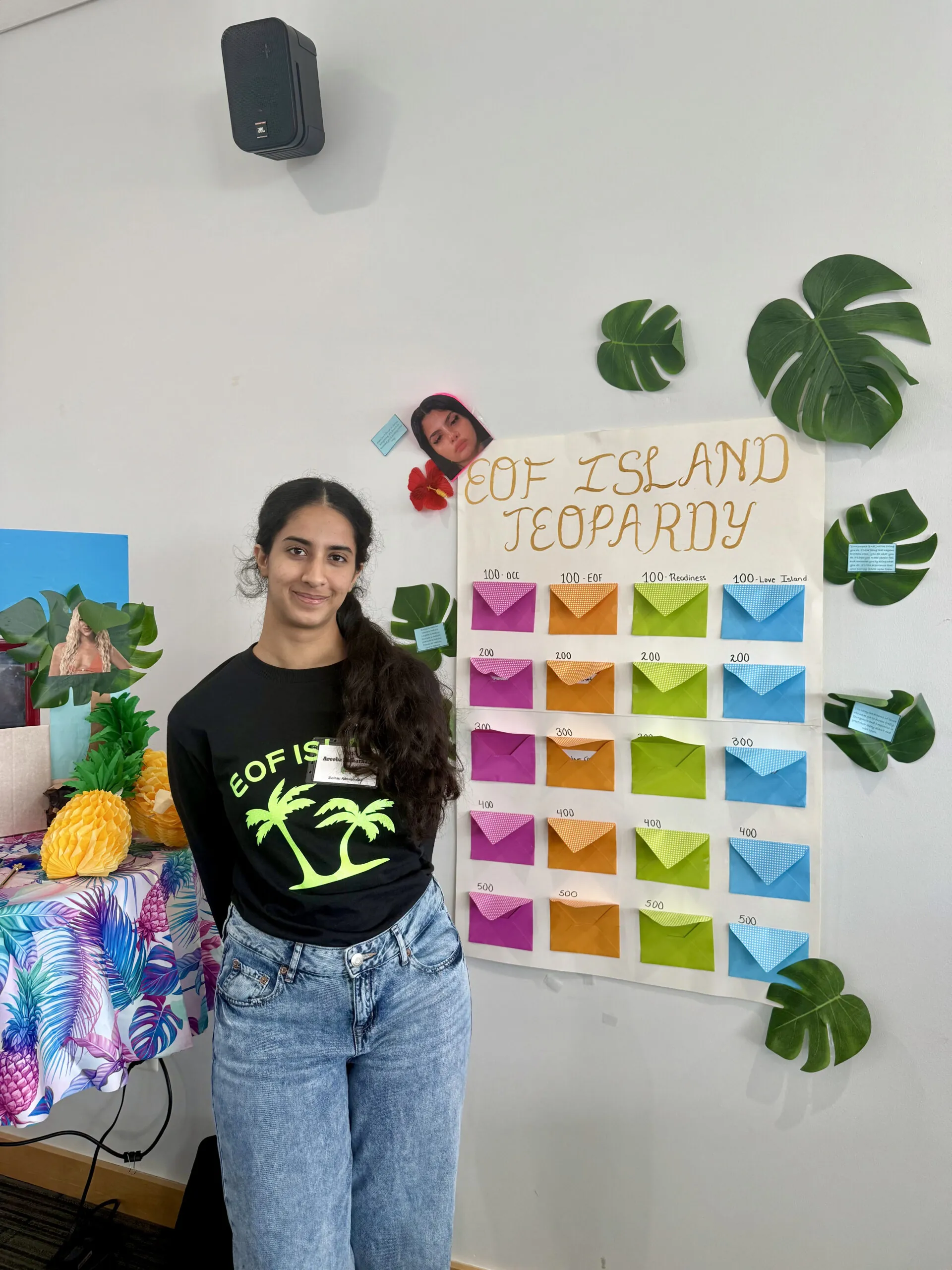 EOF student leader posing in front of a jeopardy poster